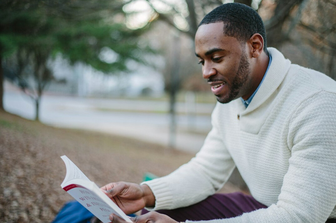 person reading self help book